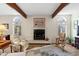 Living room showcasing a fireplace with tile surround and wood beam ceiling at 3005 Ocean Winds Dr, Seabrook Island, SC 29455