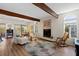Cozy living room with wood beams, a tile fireplace, and a sun-filled window at 3005 Ocean Winds Dr, Seabrook Island, SC 29455