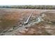 A long wooden boardwalk stretching across a marshy landscape with a stream, leading to distant trees and possible homes at 3020 Plumier Pl, Charleston, SC 29414