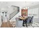 Elegant dining area with a modern chandelier, wood table, and staircase in view at 3020 Plumier Pl, Charleston, SC 29414
