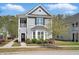 Charming two-story home with a cozy front porch and beautifully landscaped front yard at 3020 Plumier Pl, Charleston, SC 29414