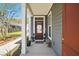 Inviting front entry with a dark wood door, nautical decor, and a covered porch at 3020 Plumier Pl, Charleston, SC 29414