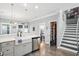 Open concept kitchen with white cabinetry, stainless steel appliances, and a view of the staircase at 3020 Plumier Pl, Charleston, SC 29414