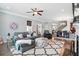 Comfortable living room features a large sectional, fireplace, and open layout to dining area at 3020 Plumier Pl, Charleston, SC 29414