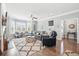Bright and airy living room with a fireplace, cozy seating, and a large bay window at 3020 Plumier Pl, Charleston, SC 29414