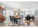 Open-concept living and dining area with abundant natural light and hardwood flooring at 3020 Plumier Pl, Charleston, SC 29414