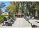 Spacious outdoor setting featuring a brick fireplace and ample Adirondack seating, perfect for outdoor entertaining at 3020 Plumier Pl, Charleston, SC 29414
