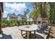 Inviting outdoor area with an open-air fireplace, Adirondack chairs, and a unique round table for gathering at 3020 Plumier Pl, Charleston, SC 29414
