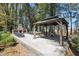 A serene outdoor space featuring a stone fireplace, a charming gazebo, and comfortable seating, perfect for relaxation at 3020 Plumier Pl, Charleston, SC 29414