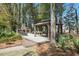 Outdoor space with a fireplace and gazebo is framed by lush landscaping and tall trees, offering a private retreat at 3020 Plumier Pl, Charleston, SC 29414