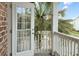 Balcony featuring white railings, tropical plants and view of the neighborhood at 3025 Lazarette Ln, Charleston, SC 29414