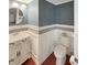Well-appointed bathroom features a vanity, tiled walls, a round mirror, and modern fixtures at 3025 Lazarette Ln, Charleston, SC 29414