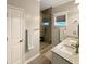 Bathroom featuring double vanity, tiled shower with glass enclosure, and neutral wall color at 3025 Lazarette Ln, Charleston, SC 29414