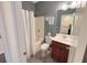 Bathroom featuring a tub with shower, gray walls, and cherry vanity at 3025 Lazarette Ln, Charleston, SC 29414