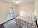 Cozy bedroom with ceiling fan, quilt bedding, and private balcony access at 3025 Lazarette Ln, Charleston, SC 29414