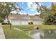 Exterior view of garages and landscaping in the community with lovely pond at 3025 Lazarette Ln, Charleston, SC 29414