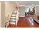 Spacious foyer featuring hardwood floors, staircase, and an open view to the dining room and kitchen at 3025 Lazarette Ln, Charleston, SC 29414
