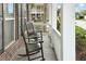 Relaxing front porch features slate flooring, rocking chairs, and white railings at 3025 Lazarette Ln, Charleston, SC 29414