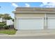 Attached two-car garage with carriage doors and exterior lighting at 3025 Lazarette Ln, Charleston, SC 29414