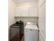 Laundry area featuring modern washer and dryer units, storage cabinets, and a clean, functional design at 3025 Lazarette Ln, Charleston, SC 29414