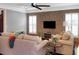 Inviting living room featuring a brick wall, large windows, and comfortable seating arrangement at 3025 Lazarette Ln, Charleston, SC 29414