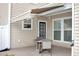 Back patio featuring a table and chairs, with an awning for shade and a view of the home's exterior at 3025 Lazarette Ln, Charleston, SC 29414