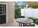 Back patio featuring a round table and chairs, with a white privacy fence, and an awning for shade at 3025 Lazarette Ln, Charleston, SC 29414