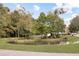 Community pond surrounded by lush landscaping and mature trees at 3025 Lazarette Ln, Charleston, SC 29414