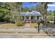 Charming home with a metal roof, cozy front porch, and well-maintained landscaping at 311 Black St, Walterboro, SC 29488
