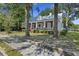 Charming front exterior of home with metal roof, porch and mature trees in yard at 311 Black St, Walterboro, SC 29488