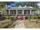 Charming home with a full covered front porch, brick pillars, and a landscaped yard at 311 Black St, Walterboro, SC 29488