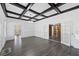 Open-concept living room with hardwood floors, coffered ceilings, and bright white walls at 311 Black St, Walterboro, SC 29488
