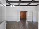 Spacious living room with coffered ceilings, white walls, beautiful wood floors, and french doors at 311 Black St, Walterboro, SC 29488