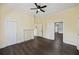 View of living room with dark wood floors and an open doorway leading to other rooms, offering flexible living space at 311 Black St, Walterboro, SC 29488
