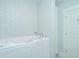 Bright, white bathroom features a modern tub with jets and white tile at 3419 Myrtle St, Edisto Island, SC 29438