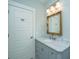 Charming bathroom with a light blue vanity and white marble countertop, paired with a gold ornate mirror at 3419 Myrtle St, Edisto Island, SC 29438