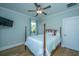Cozy bedroom with a dark wood bed, ceiling fan, and a television on the wall at 3419 Myrtle St, Edisto Island, SC 29438