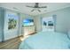 Light-filled bedroom boasting a private balcony and an elegant dresser with TV at 3419 Myrtle St, Edisto Island, SC 29438