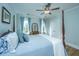 Comfortable bedroom with four poster bed, dresser and a ceiling fan at 3419 Myrtle St, Edisto Island, SC 29438