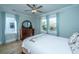 Comfortable bedroom featuring a wooden dresser, a ceiling fan and plenty of natural light from the large window at 3419 Myrtle St, Edisto Island, SC 29438