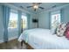 Bright bedroom featuring a four-poster bed, hardwood floors, and many windows at 3419 Myrtle St, Edisto Island, SC 29438