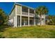 Attractive multi-story home with a lush green lawn, a charming screened-in porch, and inviting backyard at 3419 Myrtle St, Edisto Island, SC 29438