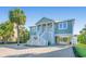 Charming coastal home with a brick driveway, staircase, and lush tropical landscaping at 3419 Myrtle St, Edisto Island, SC 29438