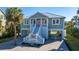 Charming coastal home with a welcoming front porch, ground floor parking and well-manicured landscaping at 3419 Myrtle St, Edisto Island, SC 29438
