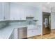 Bright kitchen featuring white cabinets, stainless steel appliances, and granite countertops at 3419 Myrtle St, Edisto Island, SC 29438