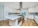 Gourmet kitchen featuring stainless steel appliances, white cabinets, and an island at 3419 Myrtle St, Edisto Island, SC 29438