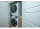 Convenient laundry closet featuring a stacked washer and dryer for efficient space-saving in this home at 3419 Myrtle St, Edisto Island, SC 29438