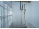 Practical outdoor shower featuring a shower head, bench and white siding, perfect for rinsing off after outdoor activities at 3419 Myrtle St, Edisto Island, SC 29438