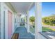 Exterior view from the porch of a charming home, looking out onto a lush landscape at 3419 Myrtle St, Edisto Island, SC 29438