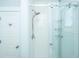 Bright white shower with glass doors, white subway tile, and a shower head at 3419 Myrtle St, Edisto Island, SC 29438